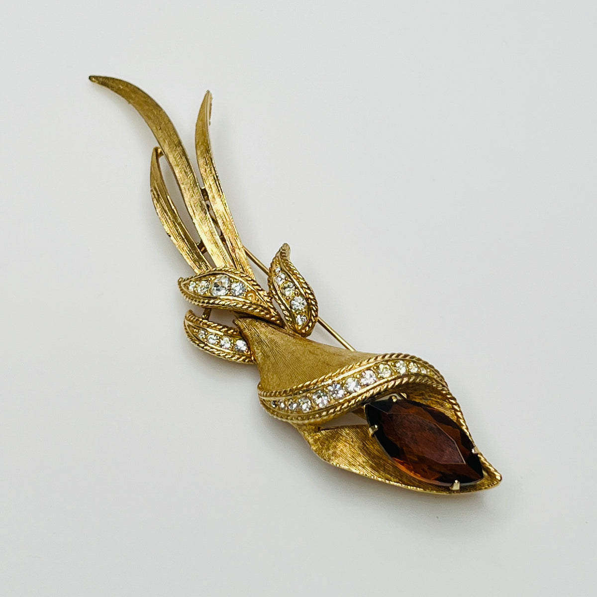 Gold-tone calla lily brooch with amber rhinestone and clear accents, signed Sarah Coventry
