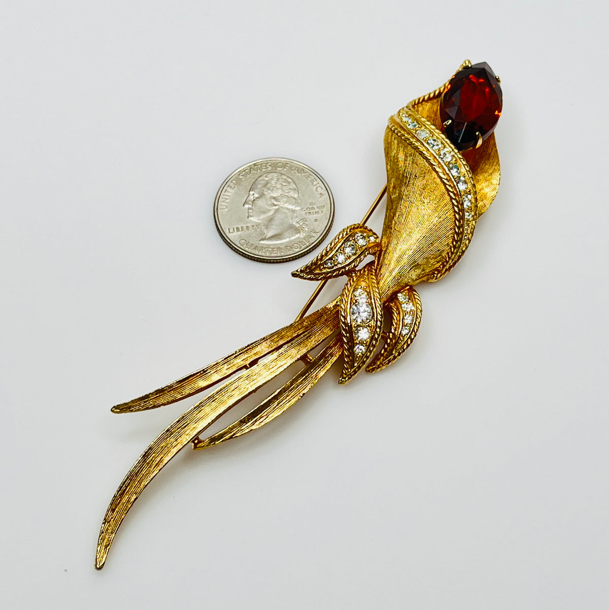 Gold-tone calla lily brooch with amber rhinestone and clear accents, signed Sarah Coventry