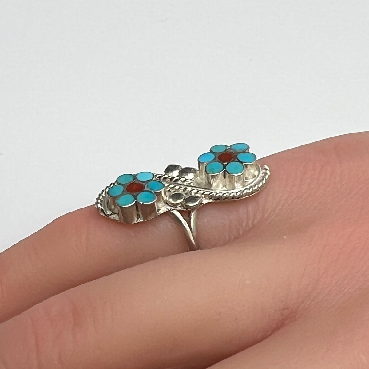 Sterling silver turquoise flower ring on hand, pinky fit with double floral design
