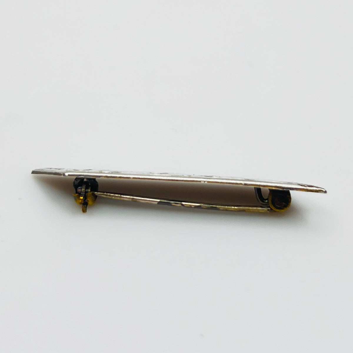 Close-up of engraved sterling silver bar brooch