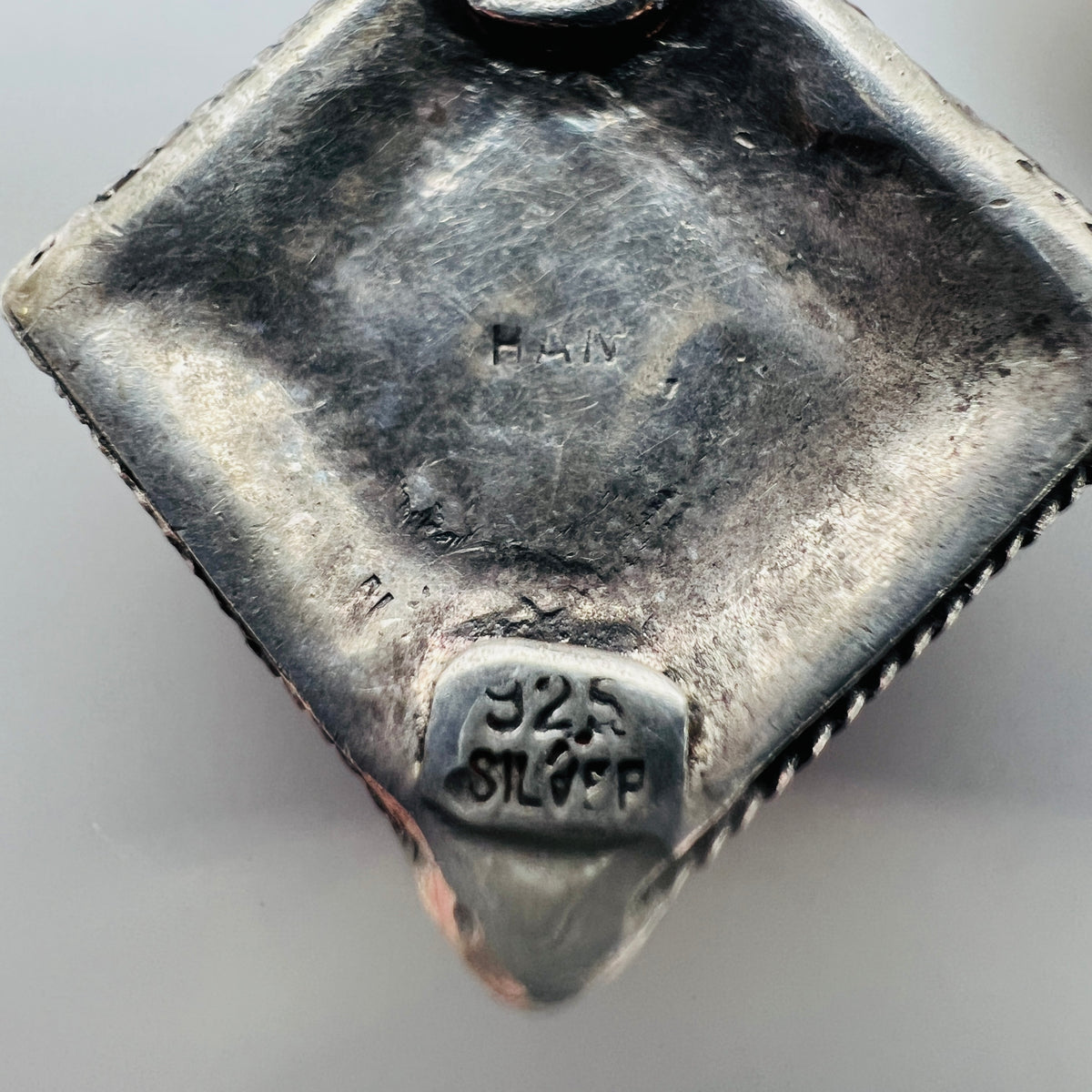Back of 925 sterling silver artisan dangle earrings