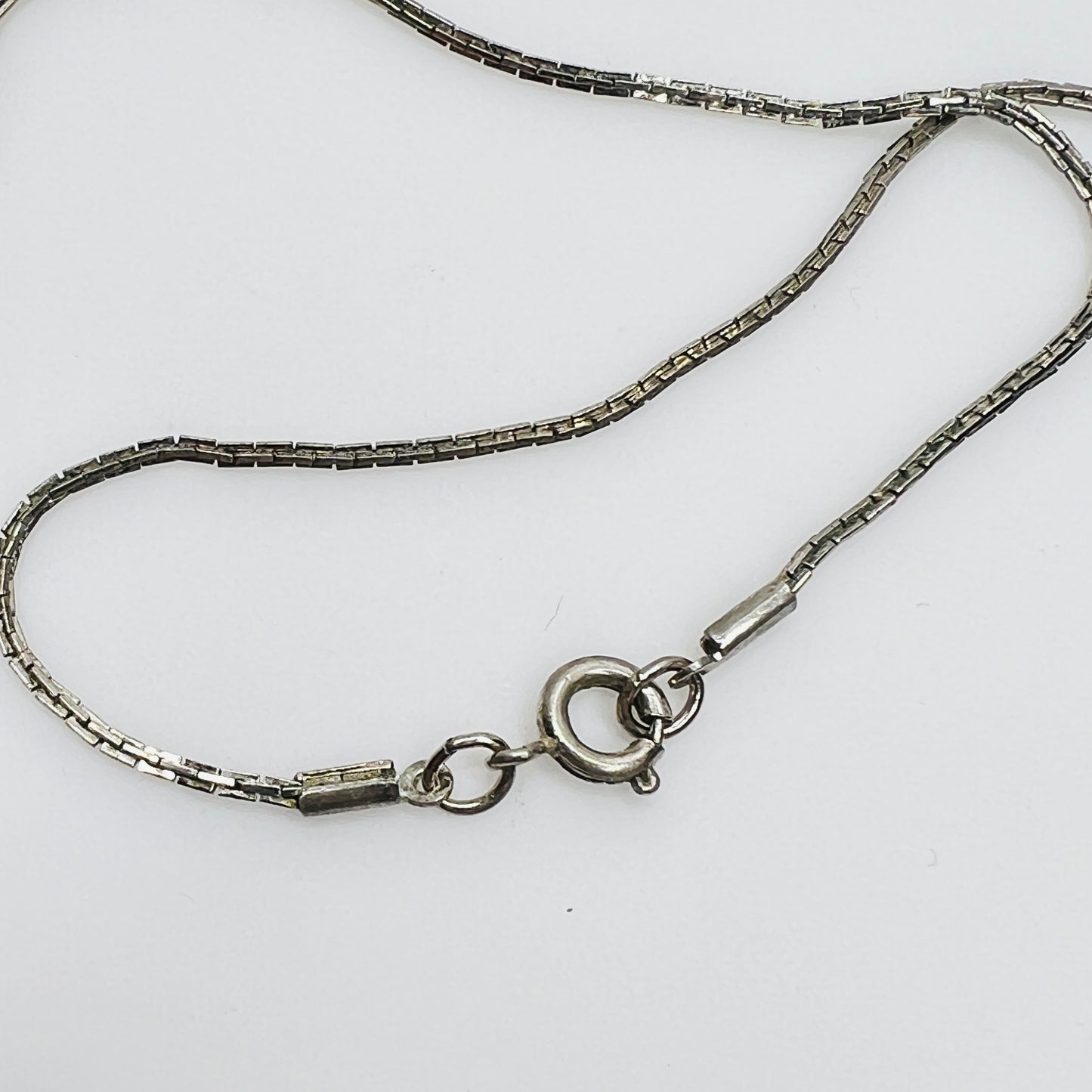 Close-up of spring ring clasp on non-sterling box chain