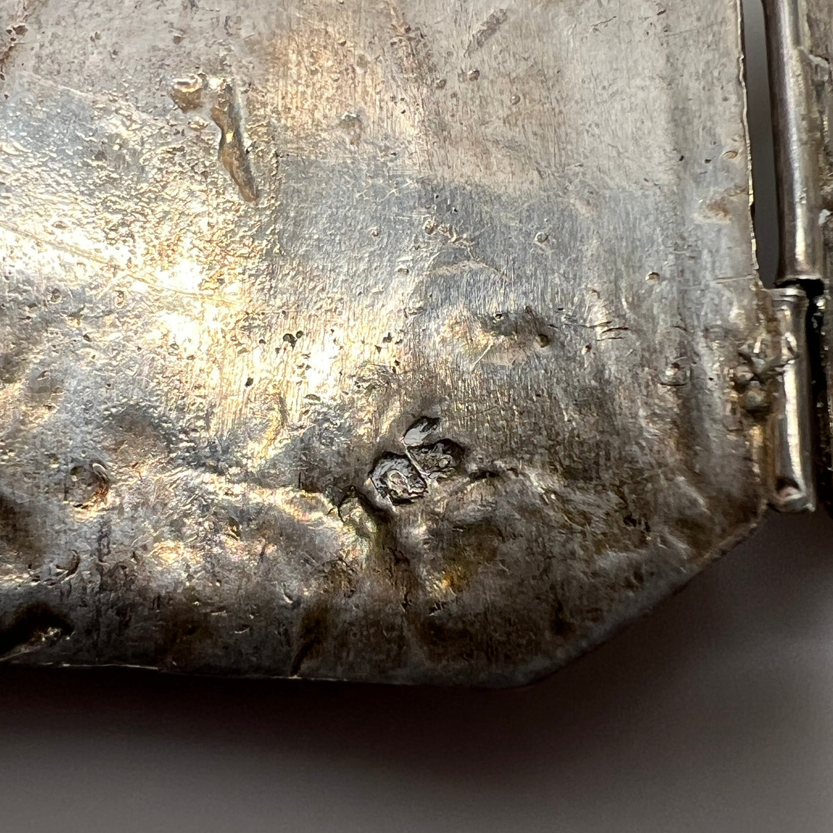 Underside of bracelet showing hand-hammered texture and partial silver marks