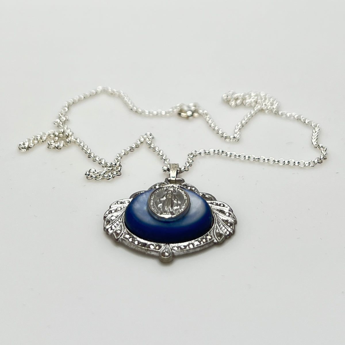 Close-up of marcasite Virgin Mary pendant with mother of pearl center