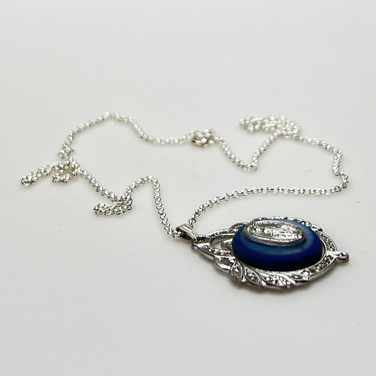 Close-up of marcasite Virgin Mary pendant with mother of pearl center