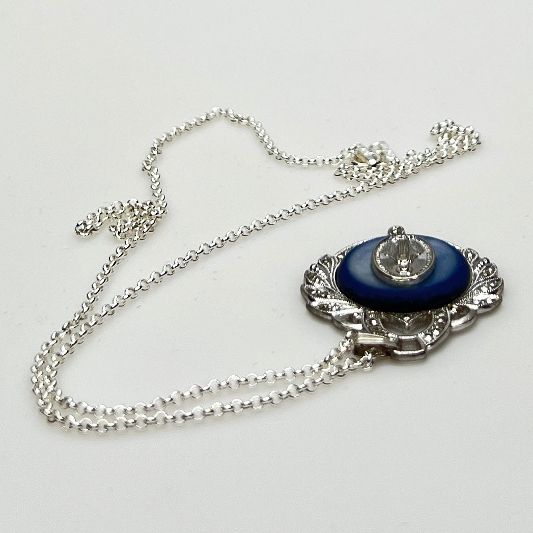 Close-up of marcasite Virgin Mary pendant with mother of pearl center