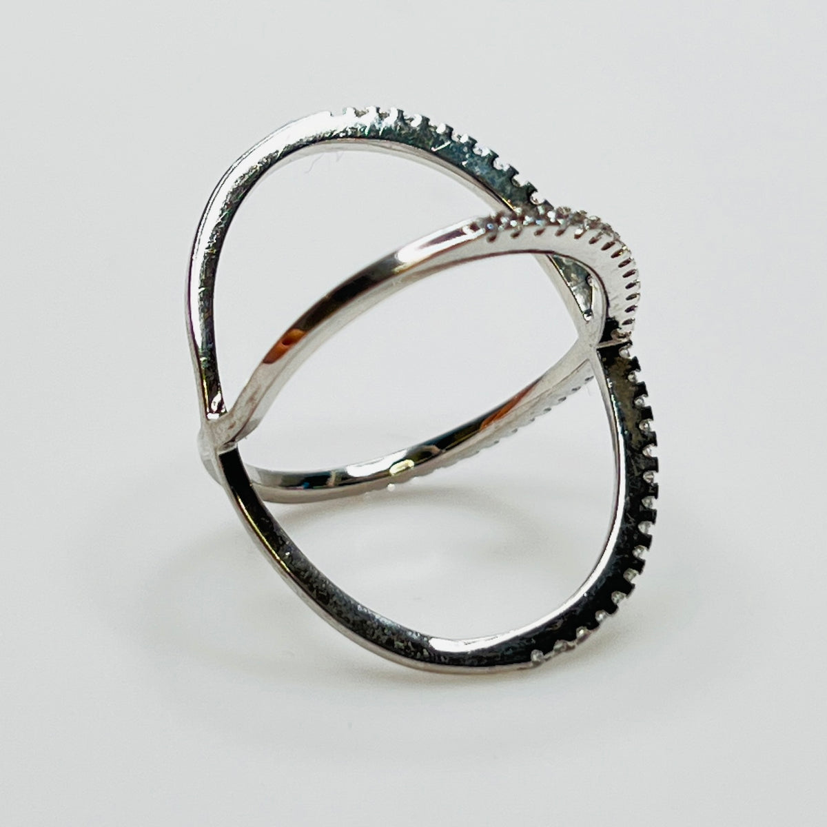 Detail of intersecting pavé CZ bands on silver ring
