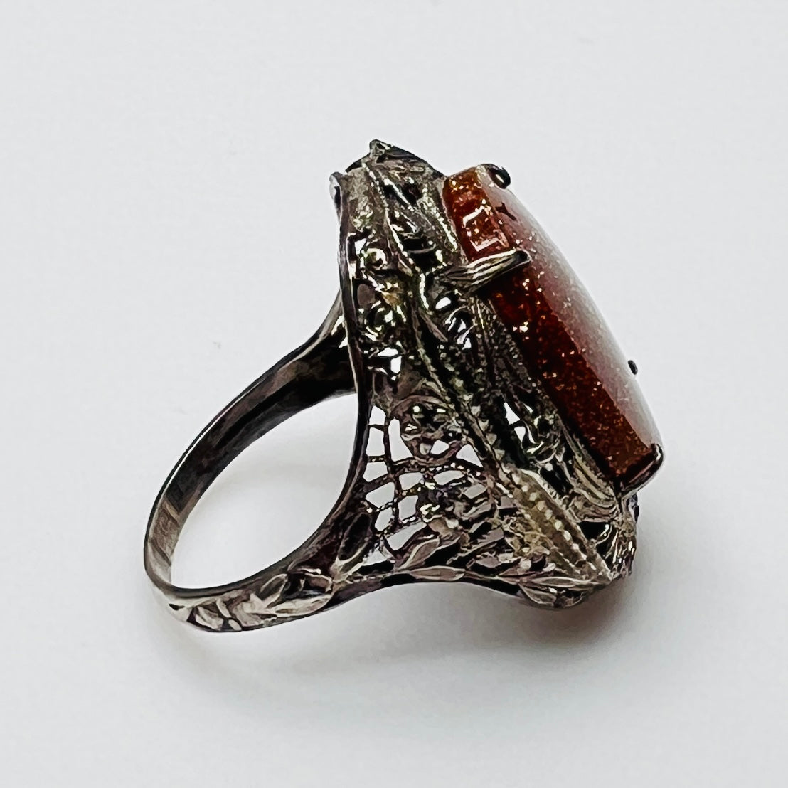 Statement vintage ring with ornate sterling floral filigree and oval goldstone
