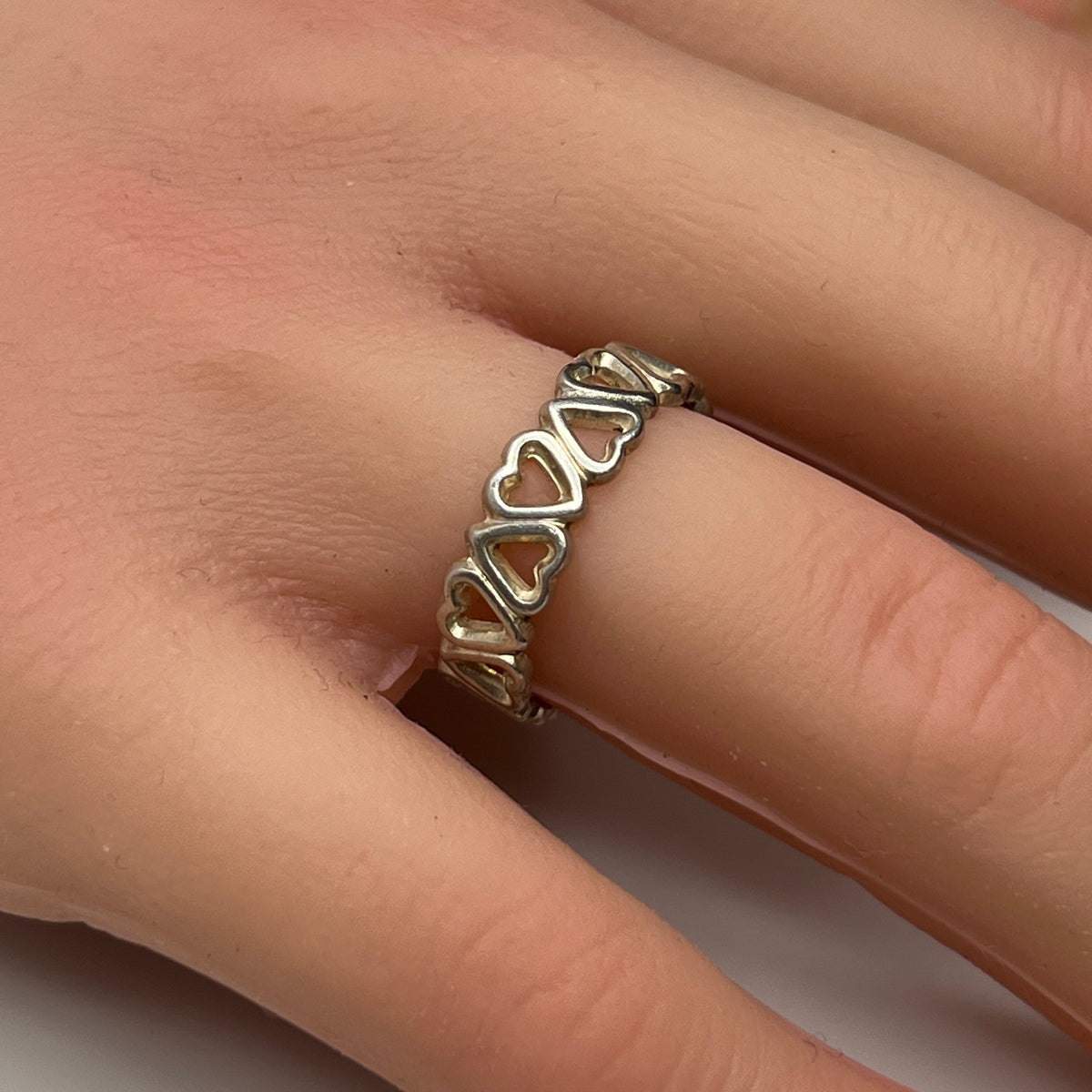 Close-up of silver open-heart design ring with 5mm band