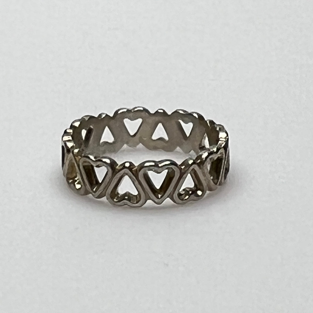 Close-up of silver open-heart design ring with 5mm band