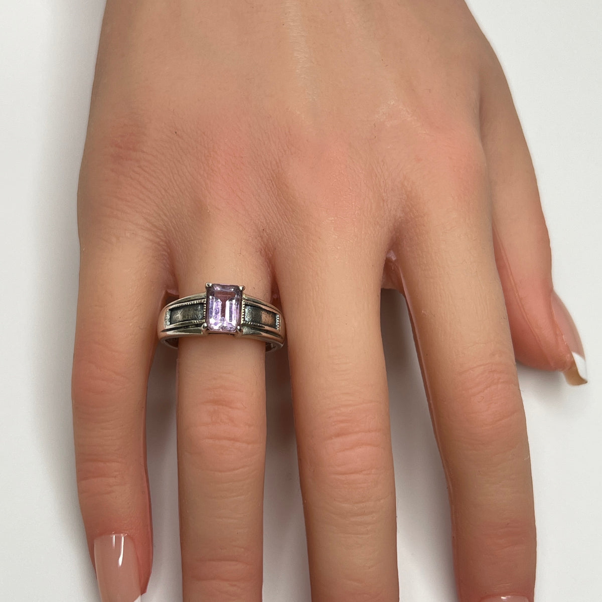 Sterling silver ring with rectangular lavender spinel worn on hand