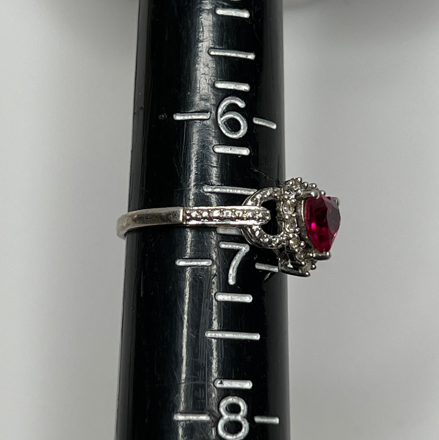 Sterling silver ring with ruby heart center and diamond halo
