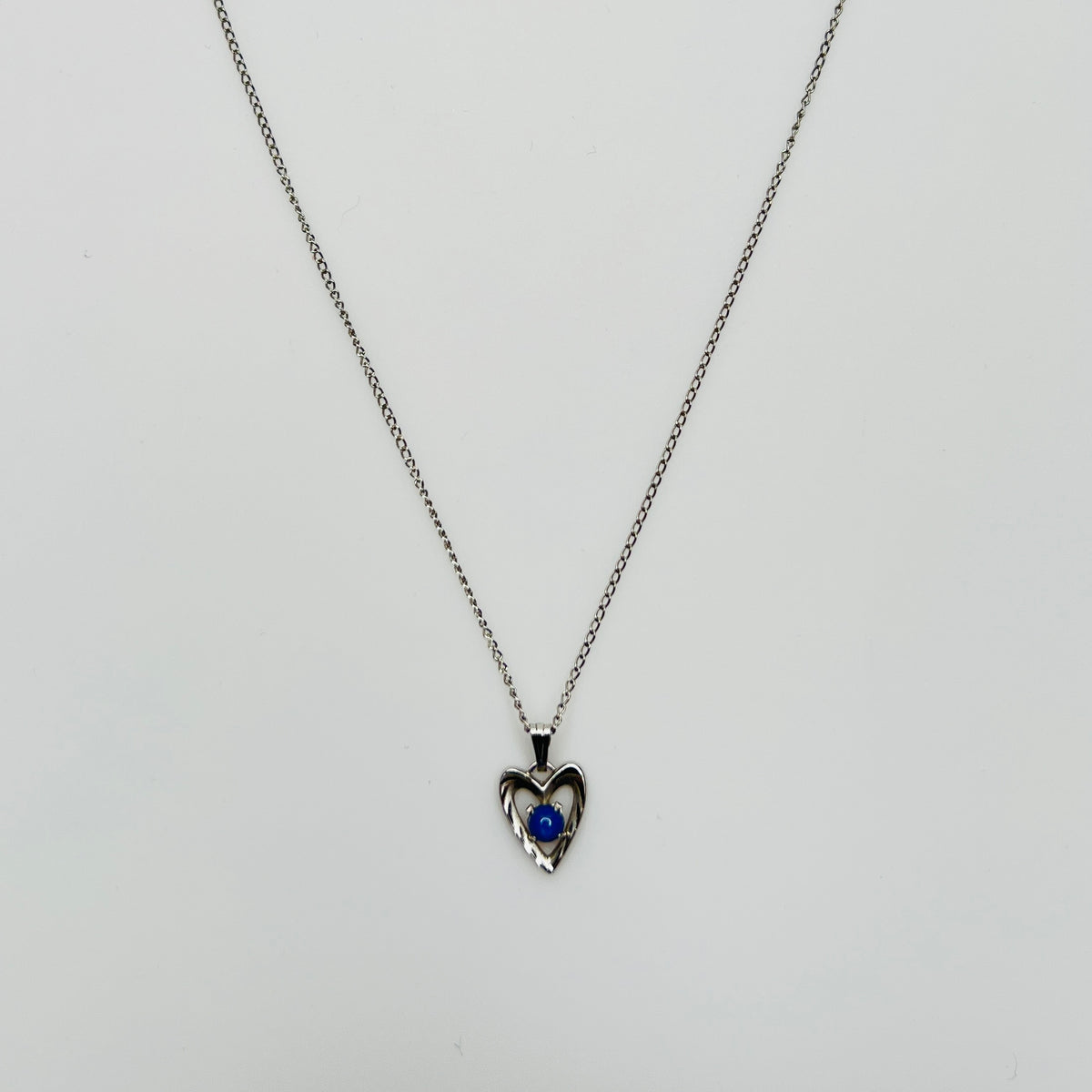 Delicate silver chain with sapphire heart pendant and spring ring clasp