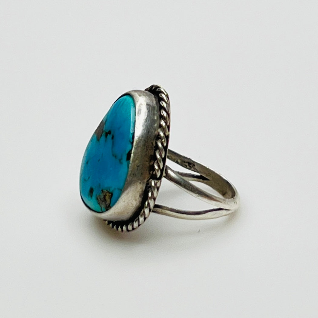 Close-up of 1970s artisan turquoise ring with twisted bezel