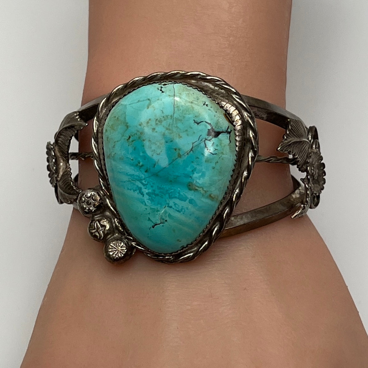 Vintage Native American turquoise and sterling silver cuff bracelet with floral motif