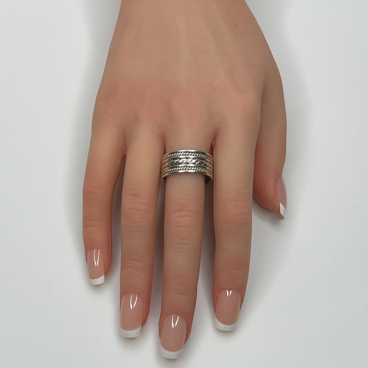 Sterling silver wide rope band ring worn on hand