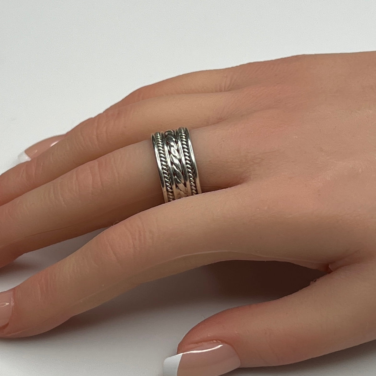 Sterling silver wide rope band ring worn on hand