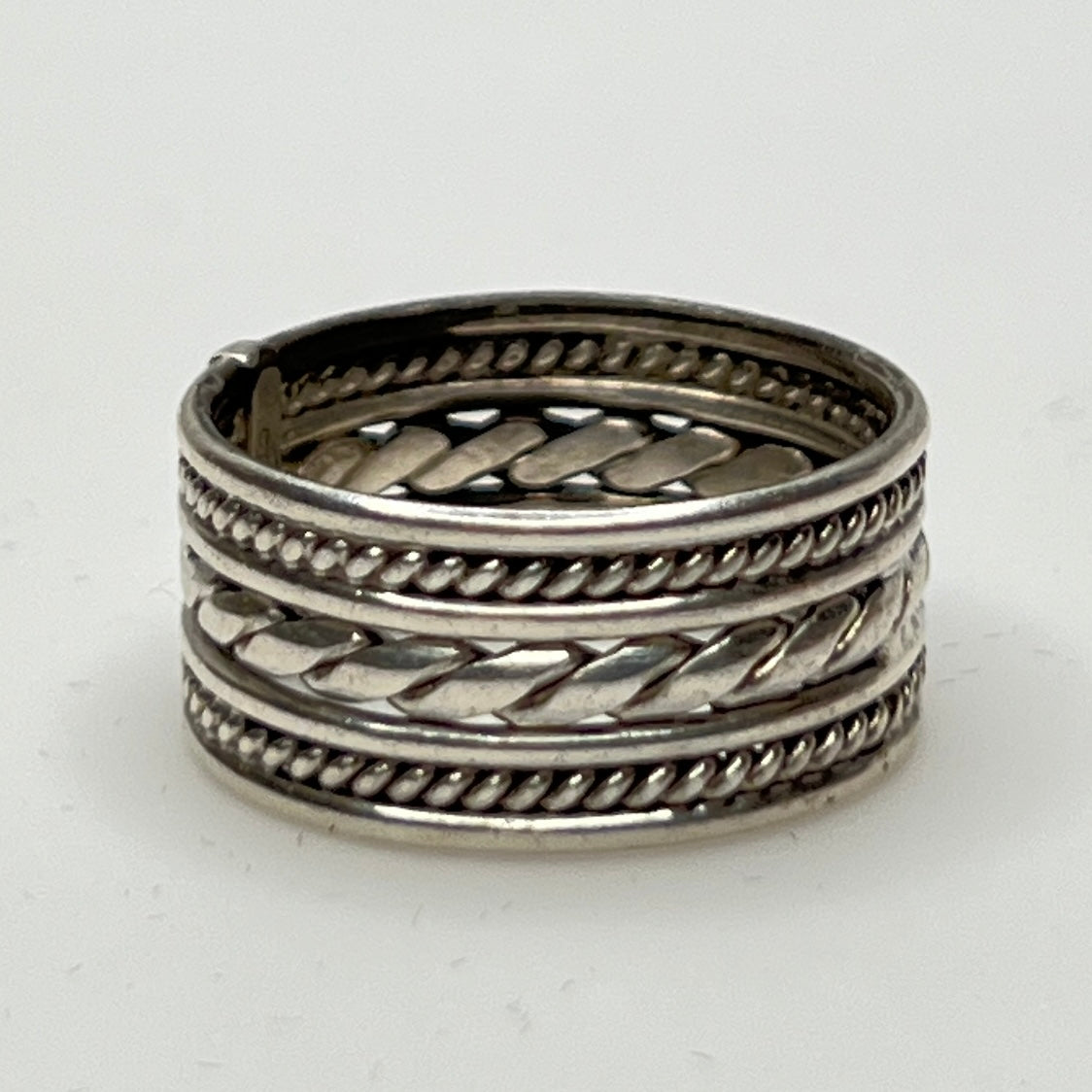 Close-up of textured braid and rope design on ring band