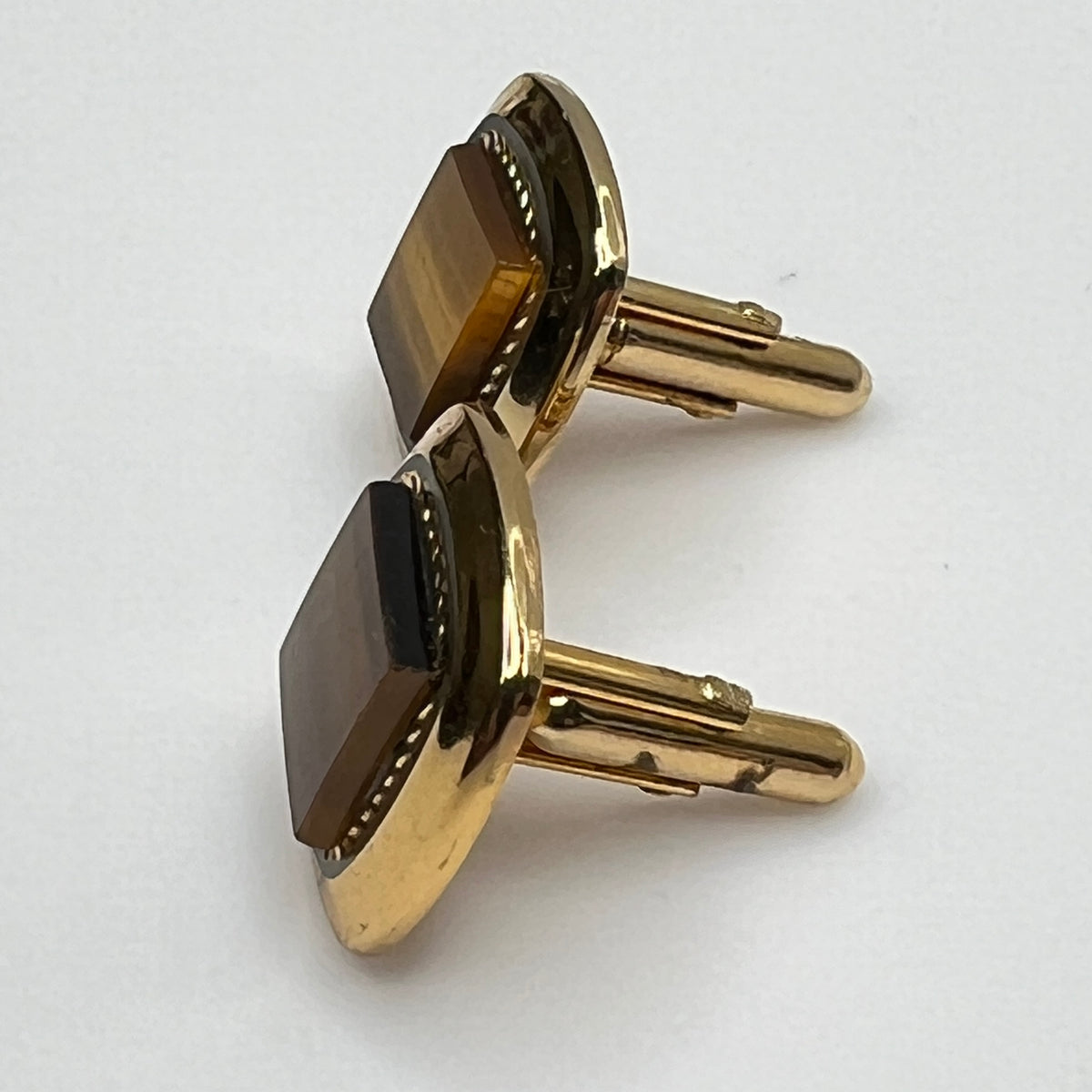 Square goldtone cufflinks with large tiger’s eye cabochons