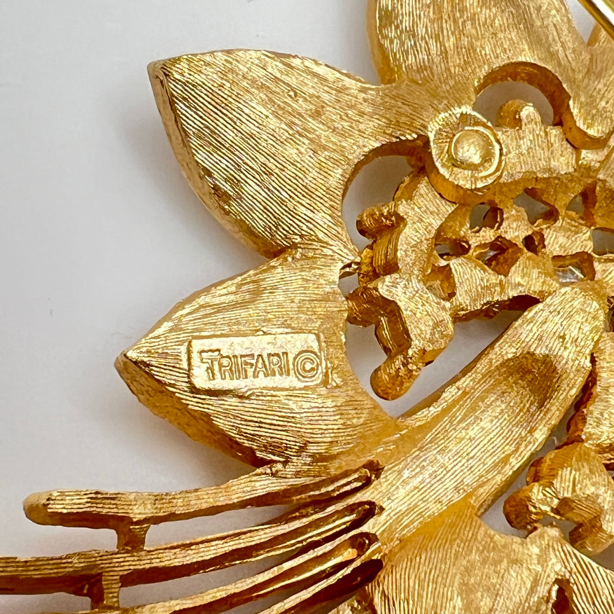 Close-up of signed Trifari flower set with starburst rhinestone details