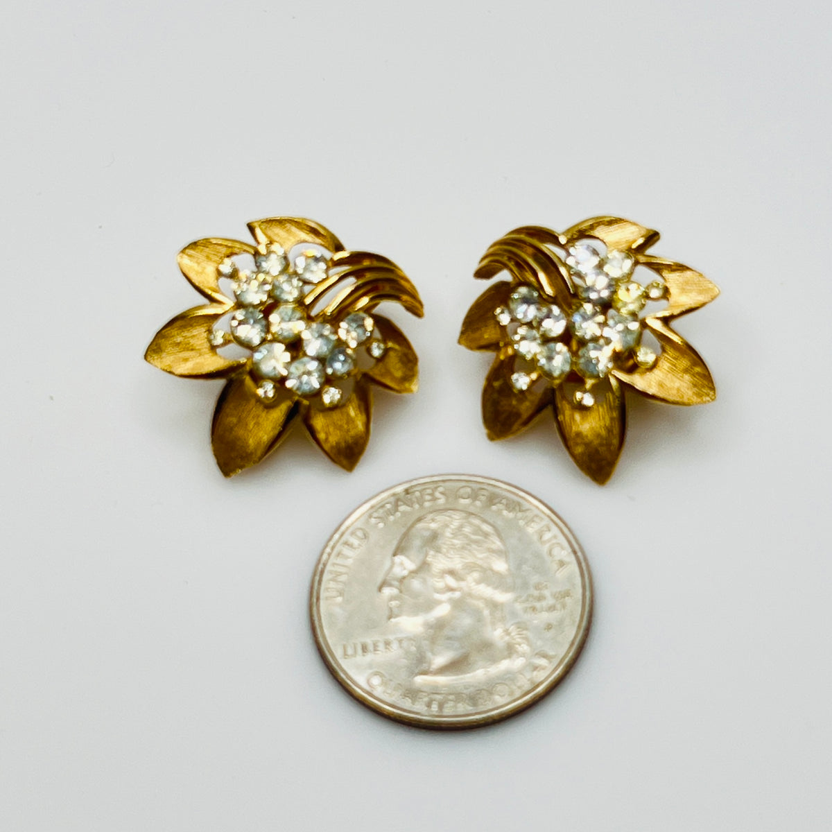 Trifari gold-tone floral clip-on earrings with rhinestone centers