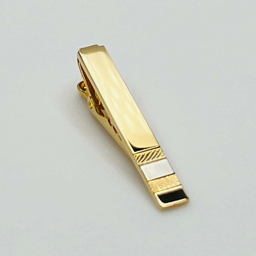 Mid-century gold and silver tone tie clip with minimalist stripe accents