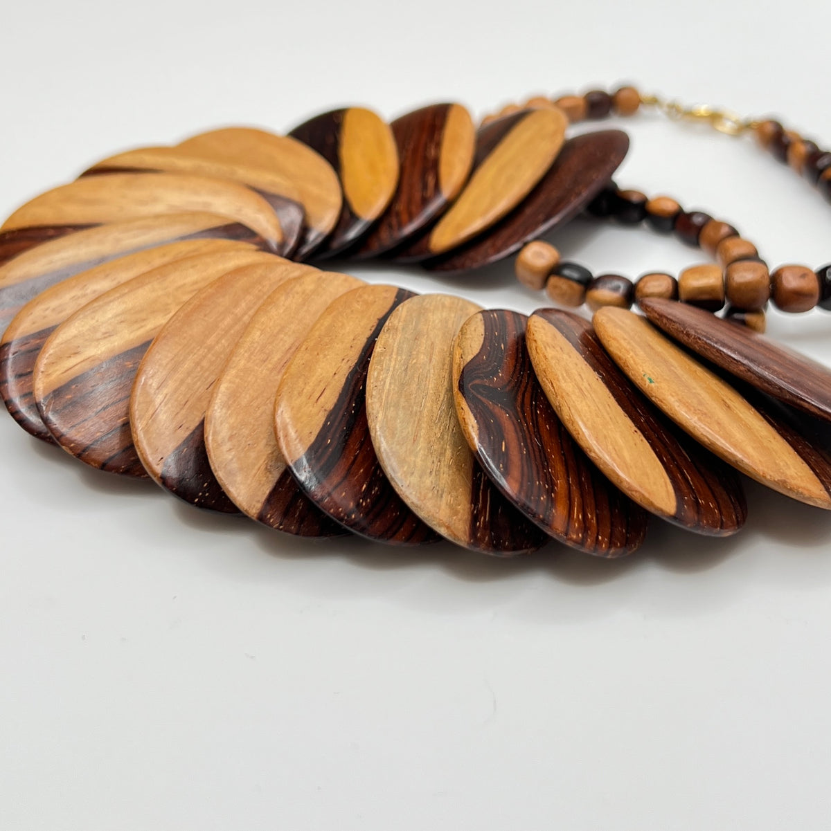 Close-up of alternating light and dark wood beads with natural grain