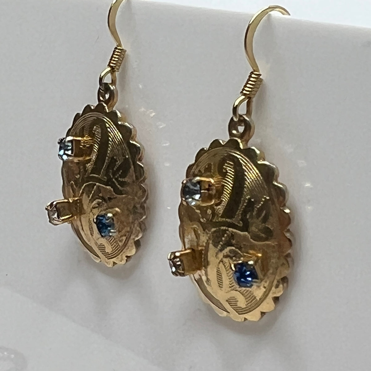 Gold-tone vintage dangle earrings with blue and clear rhinestones, ornate etched design