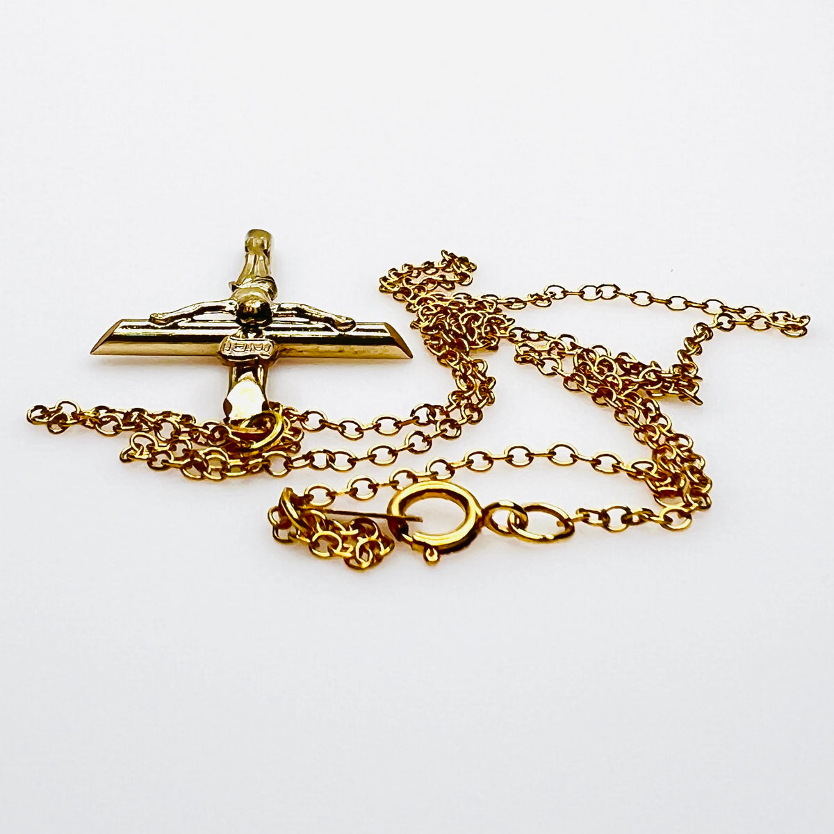 Side view of vintage gold filled crucifix pendant and matching chain.