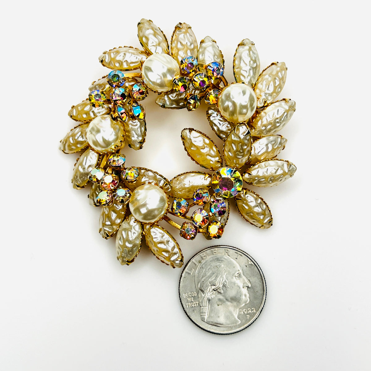 Large pearl and AB crystal wreath brooch shown beside quarter for scale