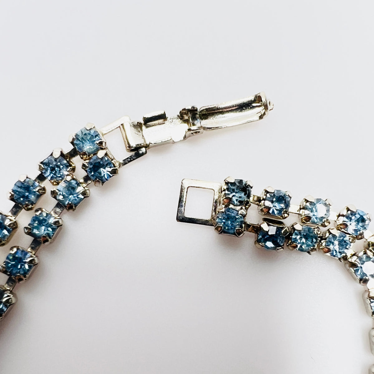 Fold over clasp detail on vintage double strand blue rhinestone bracelet
