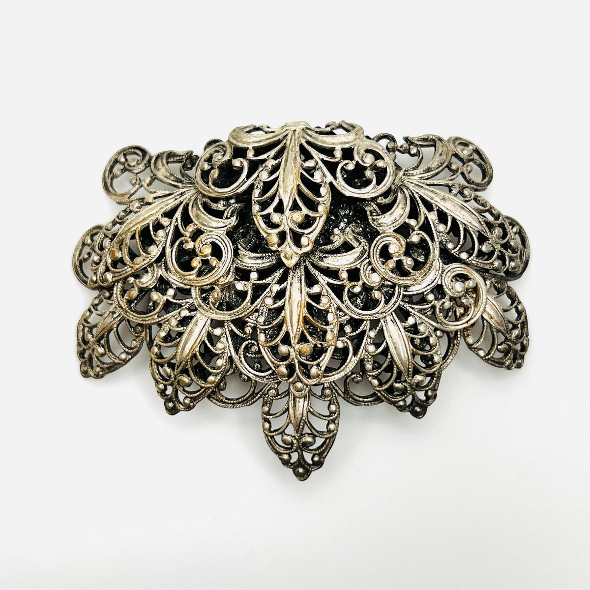Vintage 1950s silver tone fleur-de-lis filigree brooch with ornate layered scrollwork