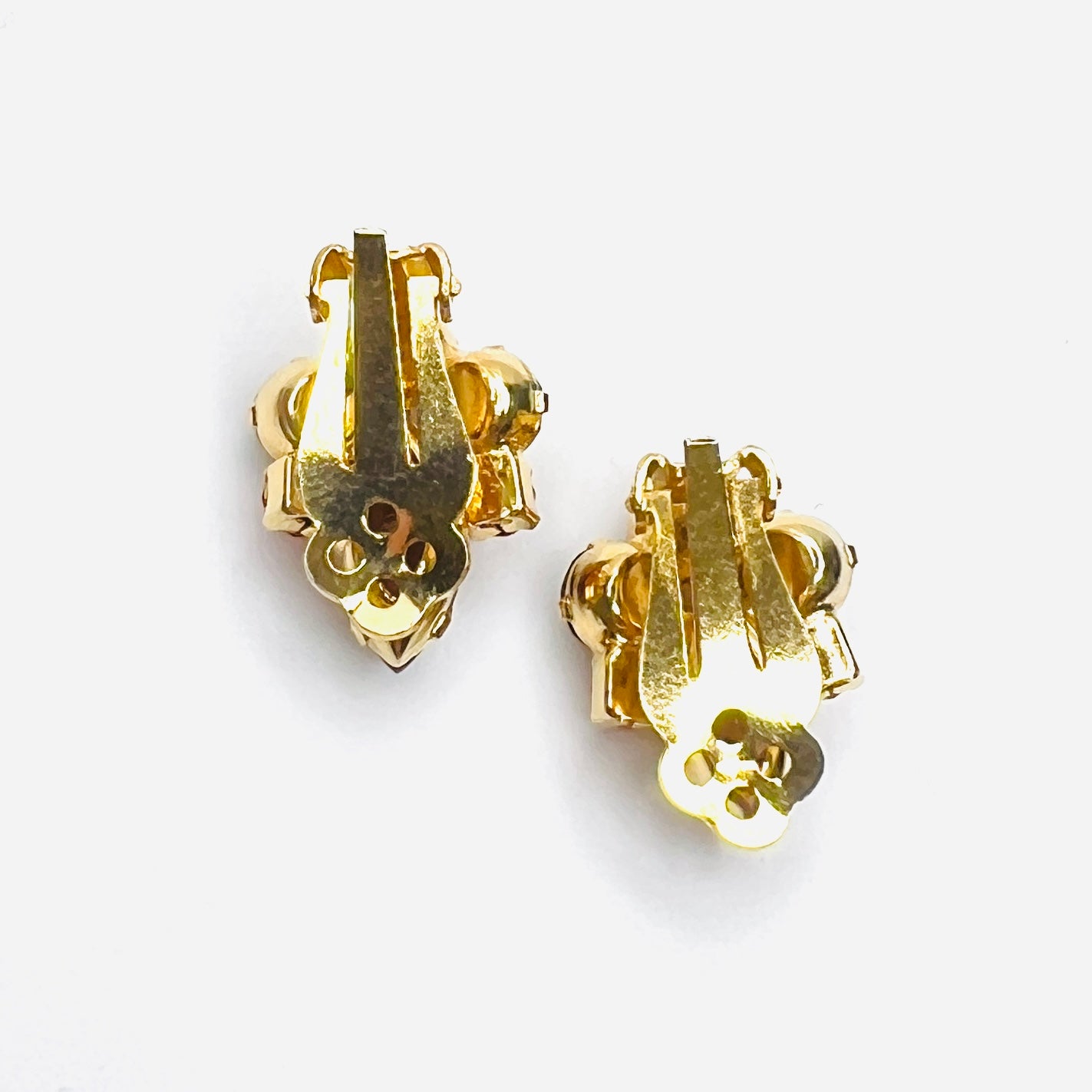 Back view of vintage gold-tone clip-on earrings with secure clips.