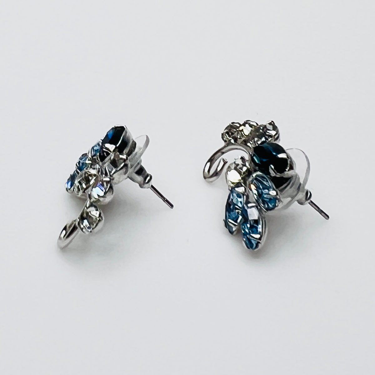 Side profile of vintage blue rhinestone spray earrings with marquise stones