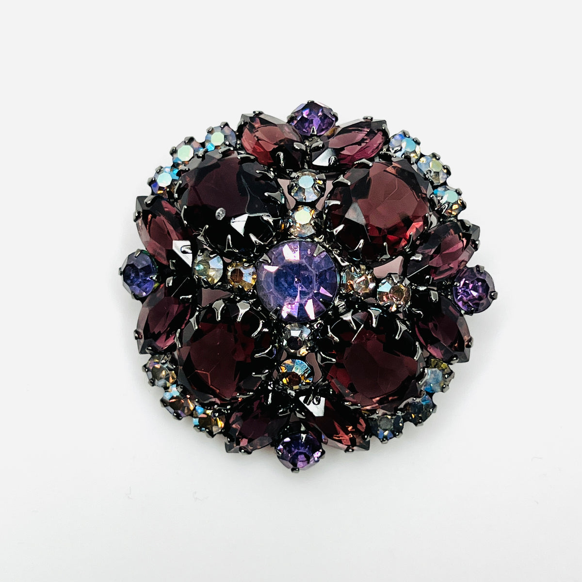 Juliana dome brooch with wine-colored oval and marquise rhinestones, violet stones, and aurora borealis accents.