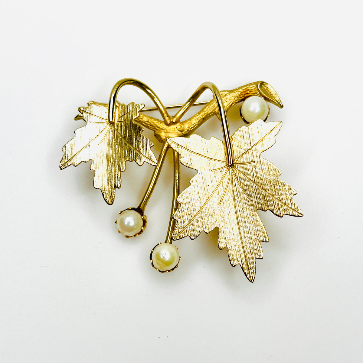 Vintage Sarah Coventry gold tone maple leaf brooch with textured leaves and cultured pearl accents