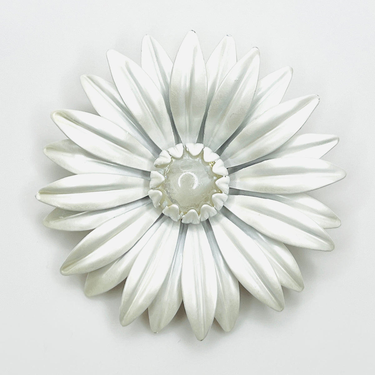 Large vintage white enamel daisy brooch with layered pointed petals and a clear domed Lucite center.