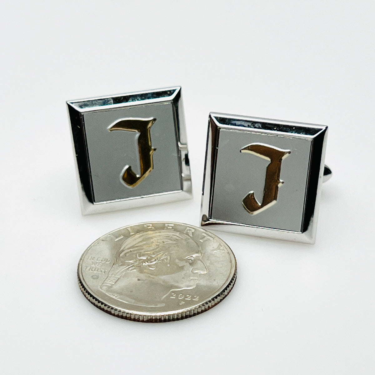 Vintage Swank initial J cufflinks beside quarter showing square design and size