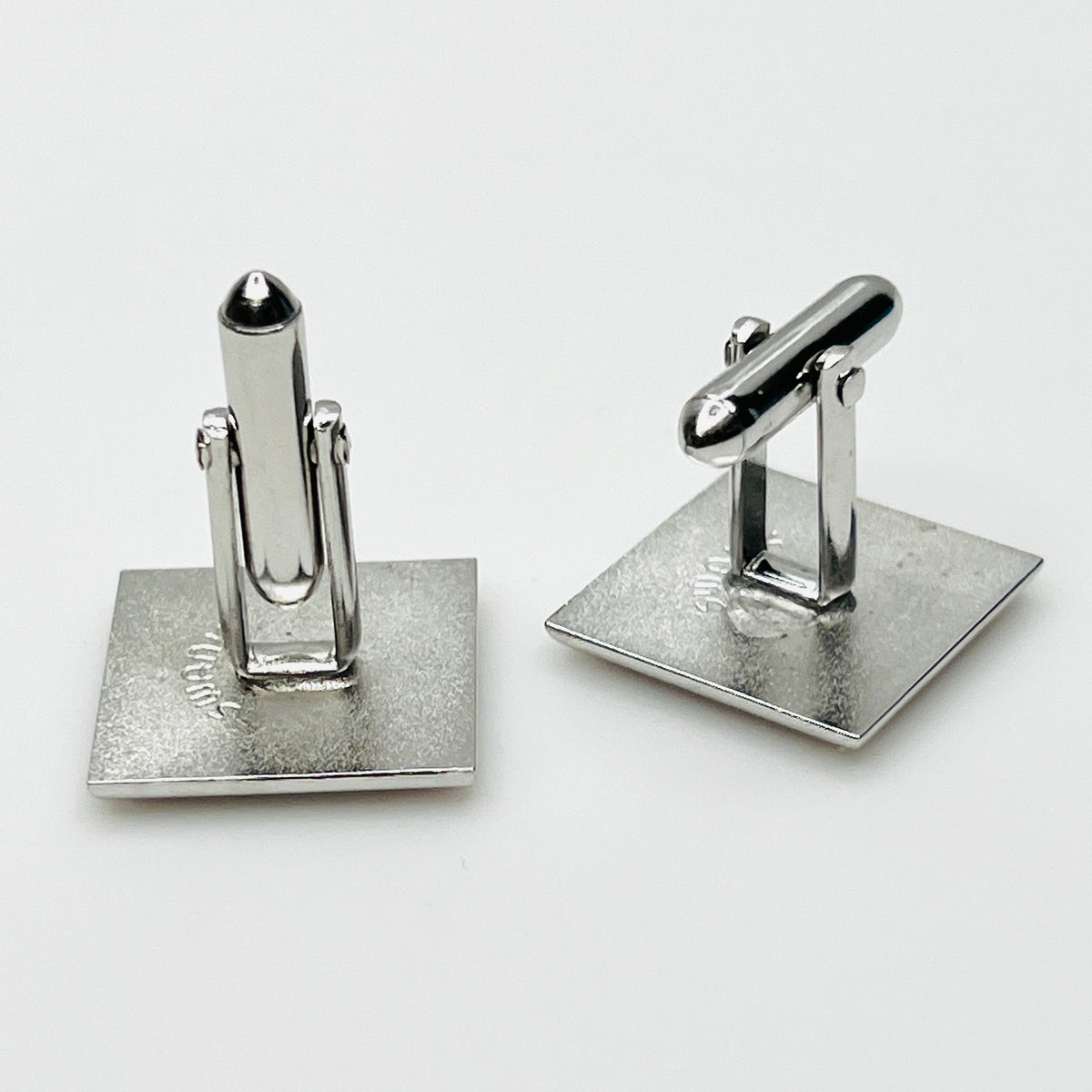 Reverse Side view of vintage Swank cufflinks showing silver tone swivel bar closures