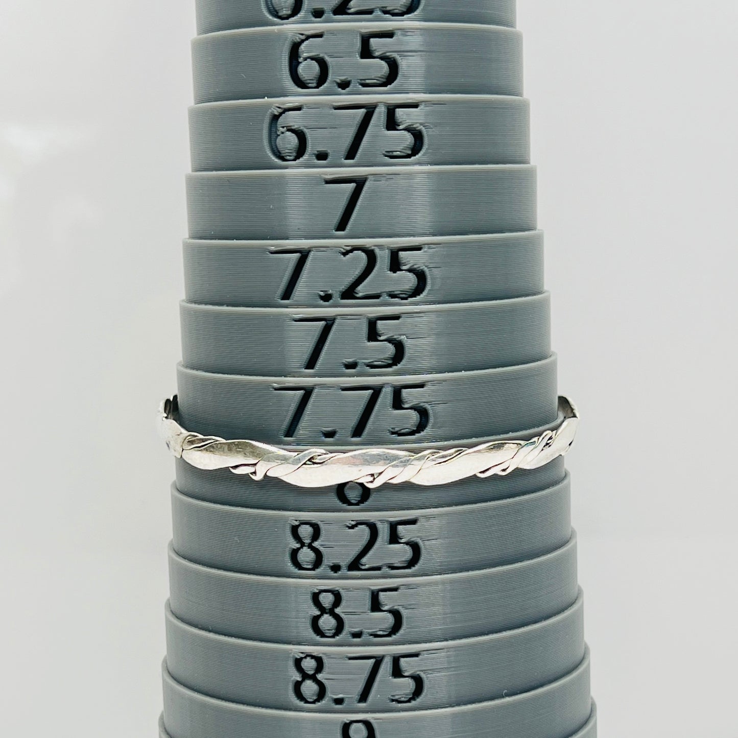 Vintage silver bangle bracelet shown with sizing mandrel