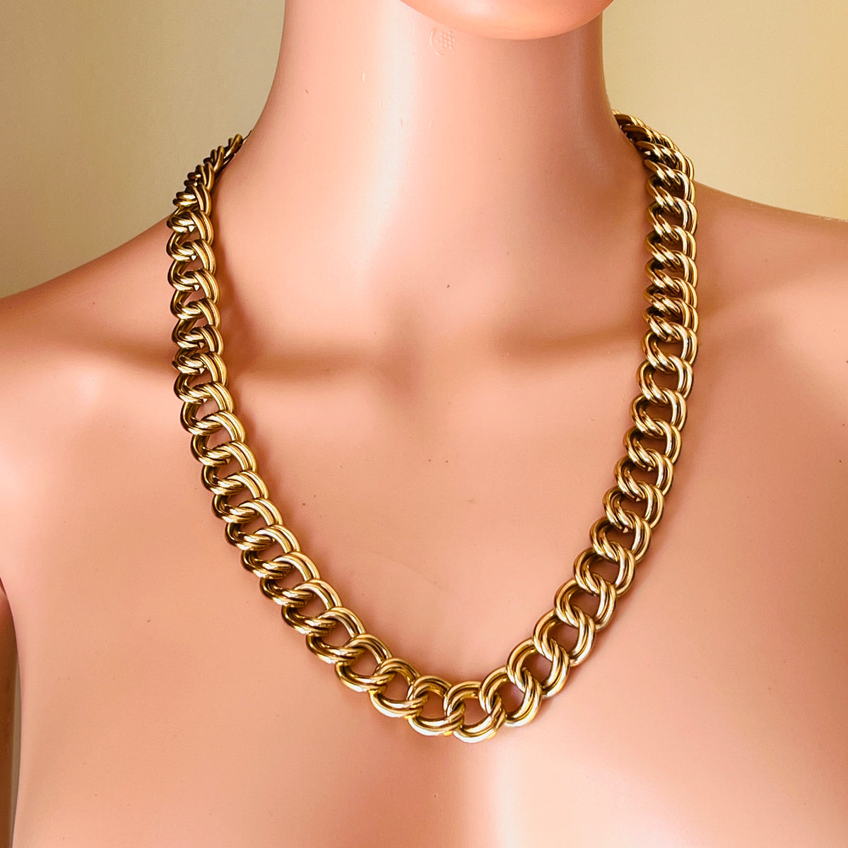 Vintage chunky gold-tone double-link necklace displayed on mannequin showing its bold statement silhouette and 23-inch length.