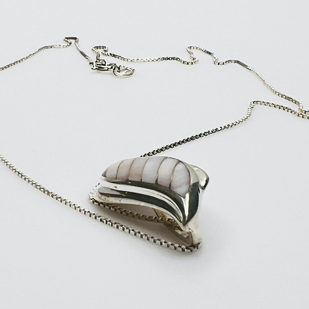 Side view sterling silver wave pendant mother of pearl detail