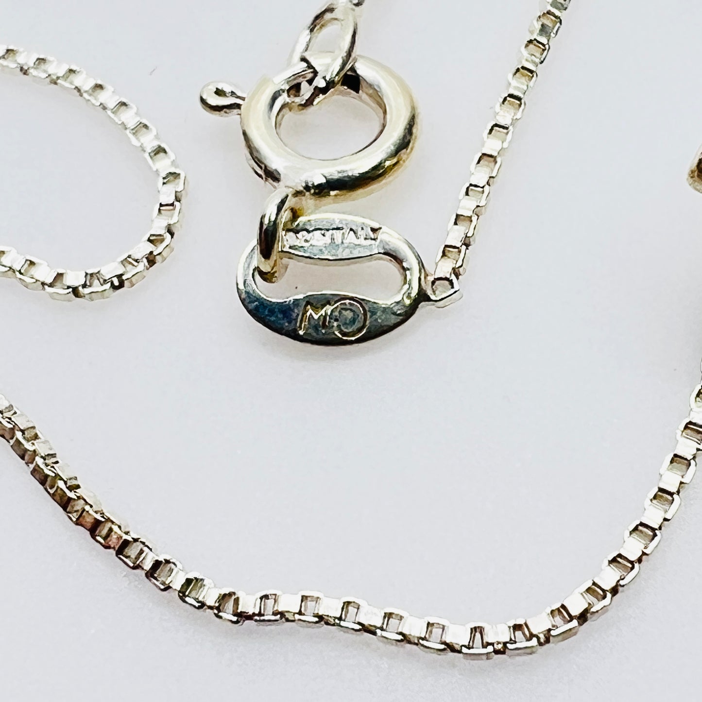 Close-up sterling silver chain clasp marked 925 Italy