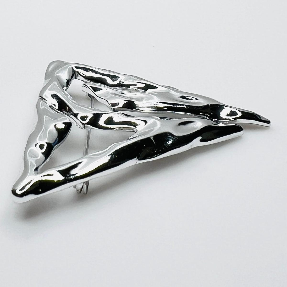 Side profile of vintage Torino abstract geometric brooch showing dimensional sculptural form.