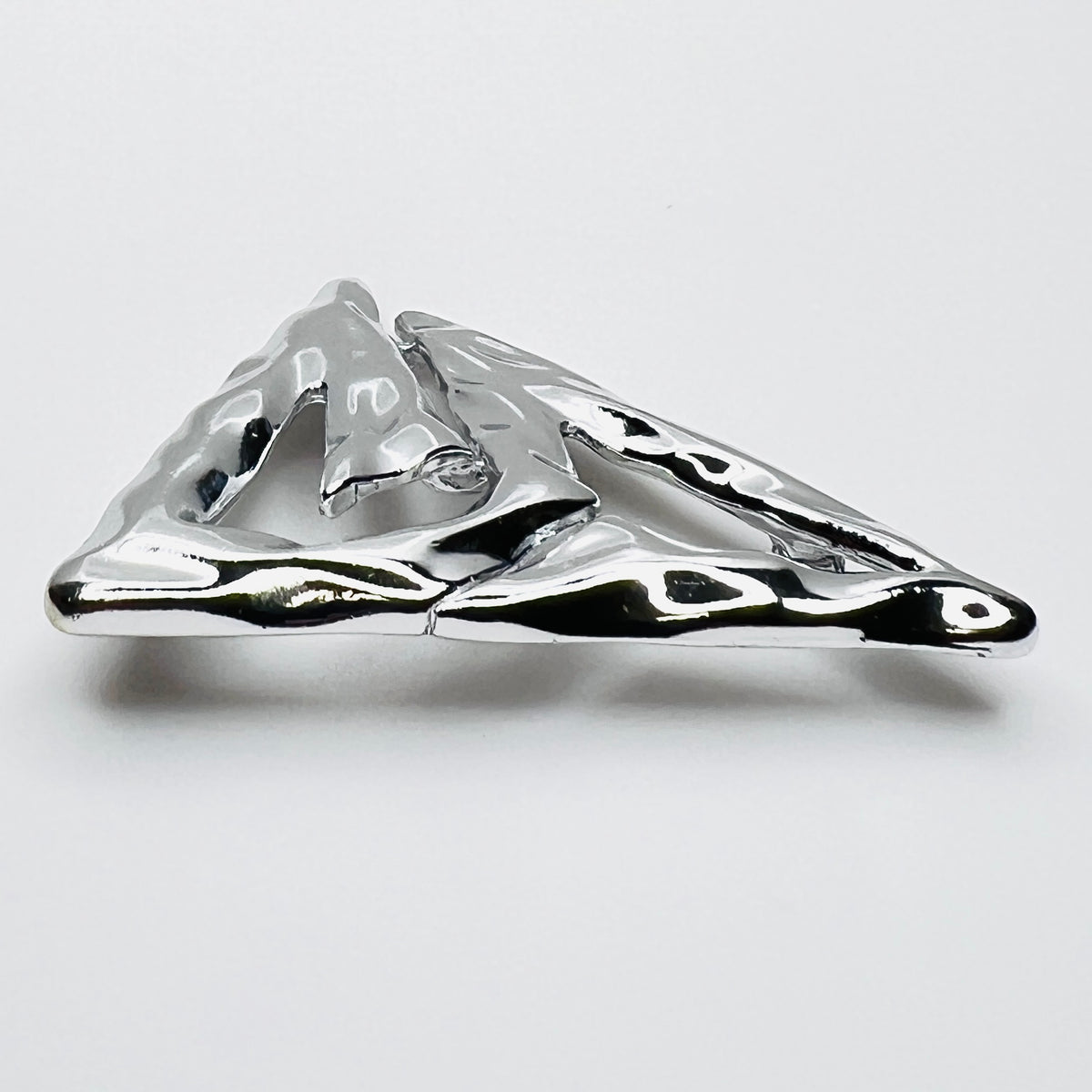 Side profile of vintage Torino abstract geometric brooch showing dimensional sculptural form.