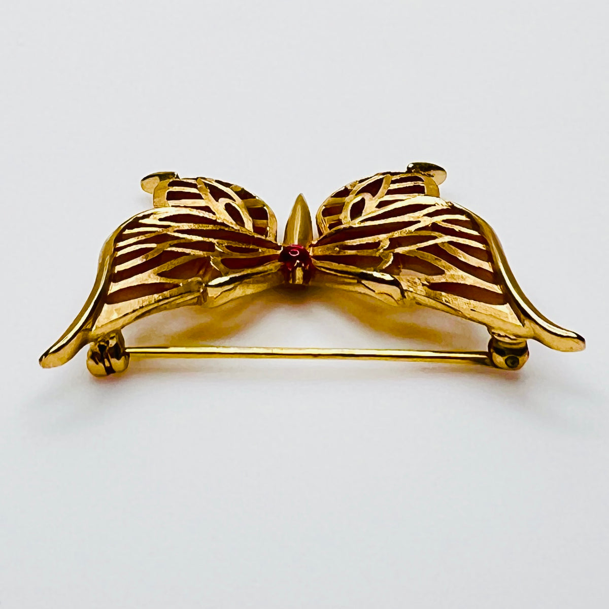Vintage gold tone butterfly brooch with red accent