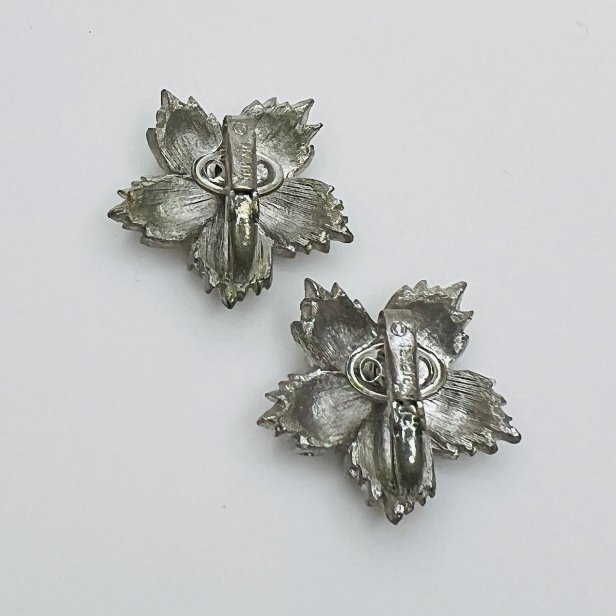 Back of signed Crown Trifari clip on earrings