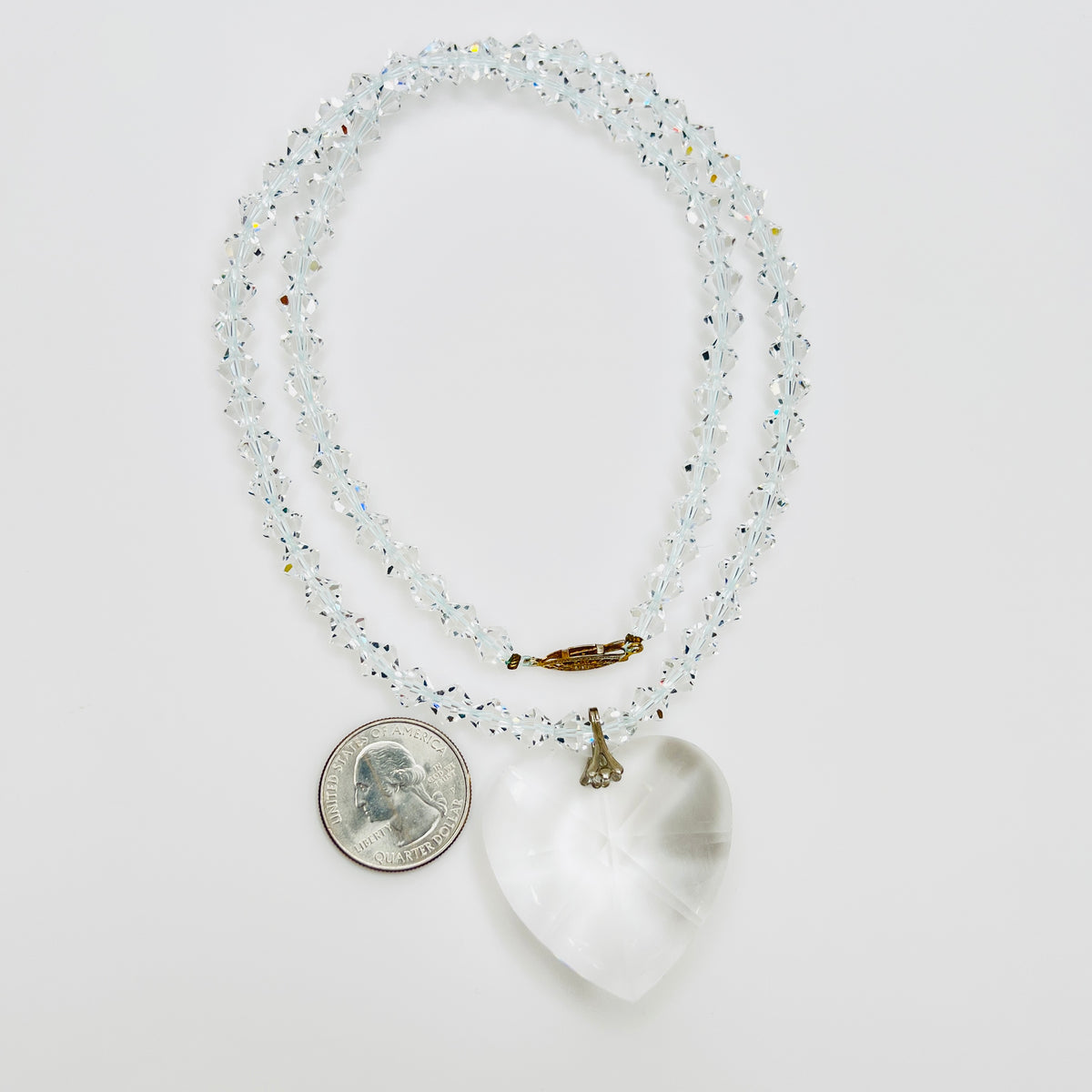 Close-up of vintage faceted crystal heart pendant on sparkling crystal bead necklace