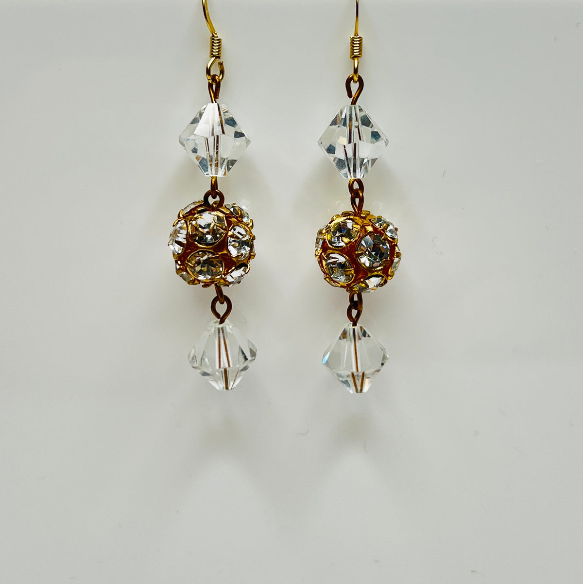 1960s crystal earrings with faceted glass and warm gold metal accents