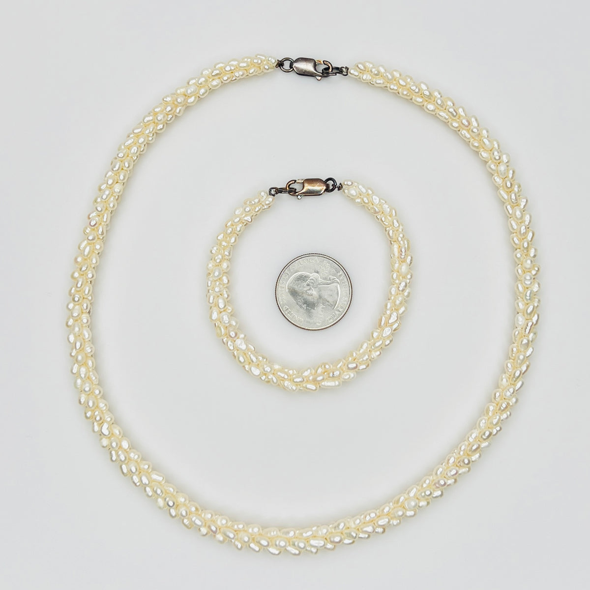 Pearl bracelet and necklace with quarter for size reference